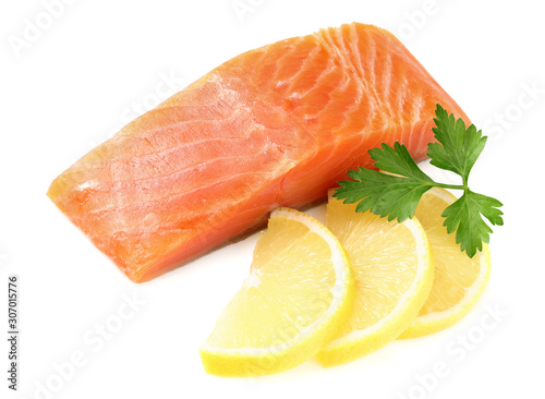 Red fish. Raw salmon fillet with parsley and lemon isolate on white background
