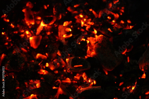 Smouldering coals at night. Decaying charcoal, New Year's Eve barbecue season