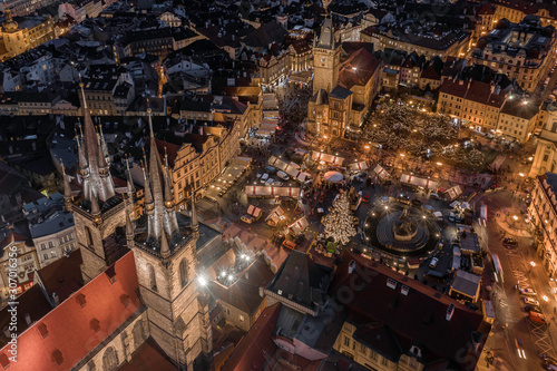 Prague  Czech Republic - Aerial drone view of the famous illuminated Church of our Lady Before Tyn towers at blue hour with traditional Christmas market  Old Town Square   Old Town Hall at background