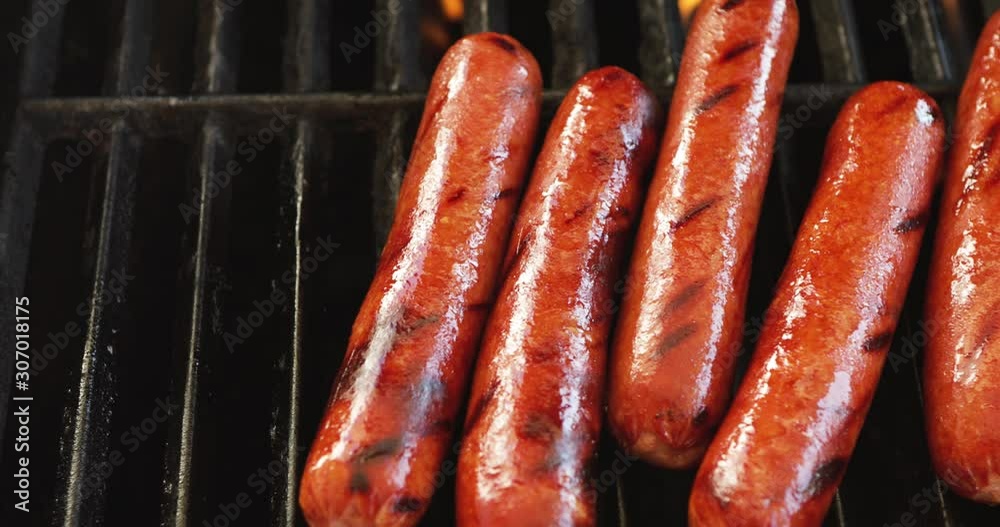 Video Slide While Removing Hot Dogs From Grill