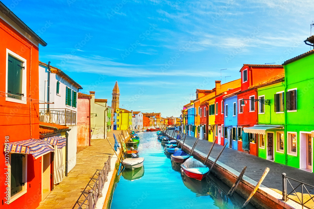 Venice landmark, Burano island canal, colorful houses, church and boats, Italy
