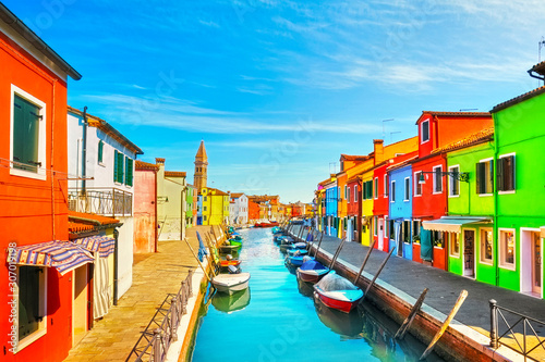 Venice landmark, Burano island canal, colorful houses, church and boats, Italy © stevanzz
