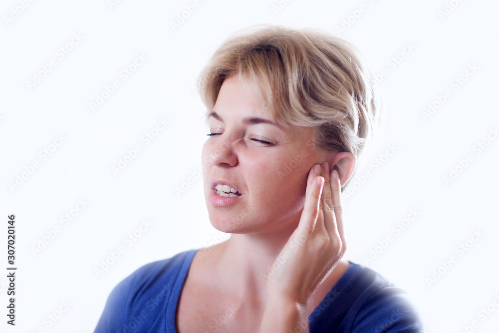 Woman feels ear pain isolated. People, healthcare and medicine concept Woman feels ear pain isolated. People, healthcare and medicine concept