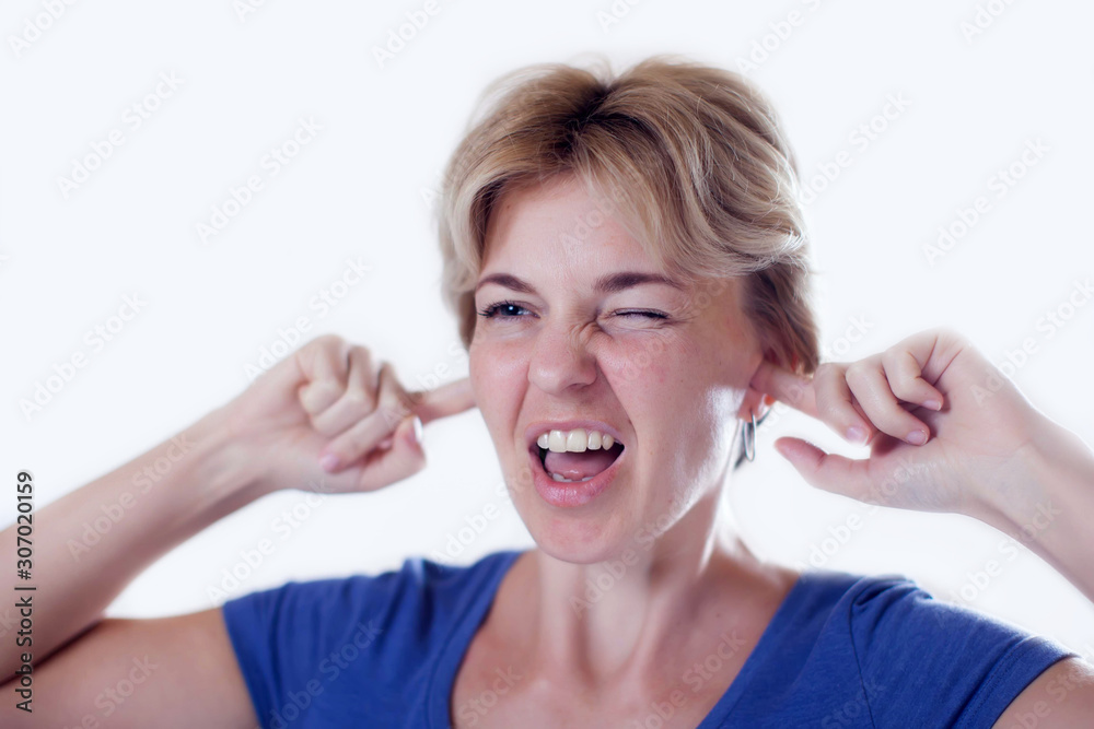 Woman feels ear pain or hearing loud sound isolated. People, healthcare and medicine concept Woman feels ear pain or hearing loud sound isolated. People, healthcare and medicine concept