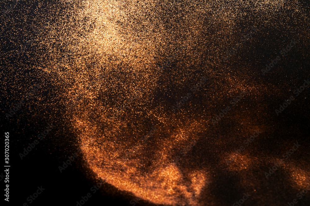 Black background with golden sparkles. Blurred effect. Concept for festive background or for project Black background with golden sparkles. Blurred effect. Concept for festive background or for project