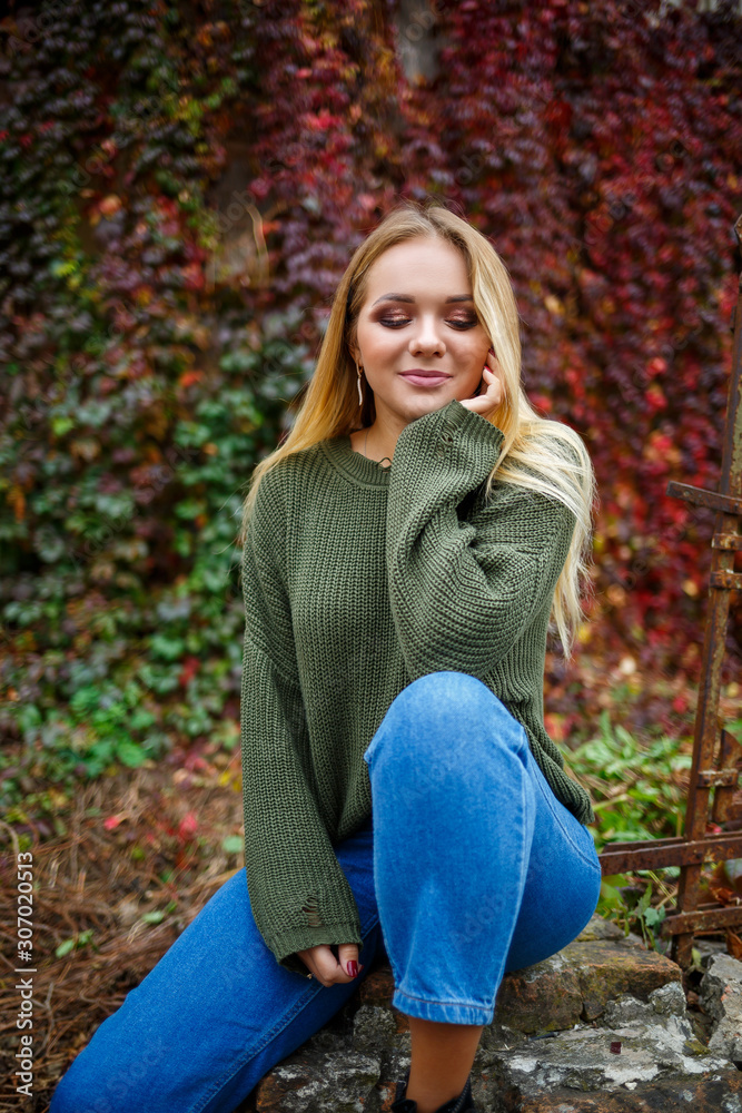 Walk of a beautiful girl in a sweater and jeans Walk of a beautiful girl in a sweater and jeans