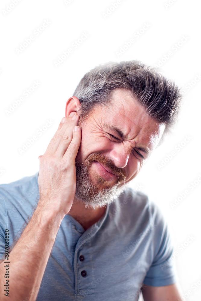 Man feels ear pain isolated. People, healthcare and medicine concept Man feels ear pain isolated. People, healthcare and medicine concept