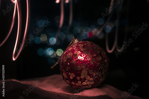 Holiday conceopt. Christmas background with baubles, on snow, free space for text. Christmas decoration. Festive background