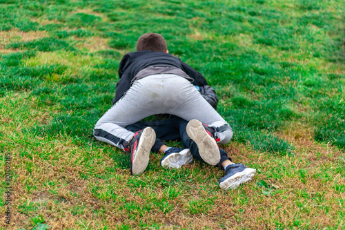 Children fight. Conflict of teens on the playground. photo