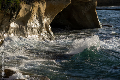 Waves of mediterranean sea hitting rocks