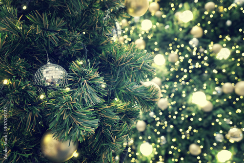 Decorated Christmas tree on blurred, sparkling background