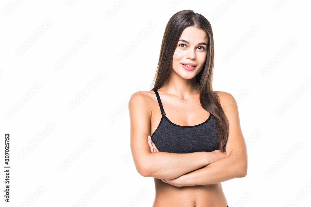 Happy fitness woman standing with arms folded over white background and looking at camera Happy fitness woman standing with arms folded over white background and looking at camera