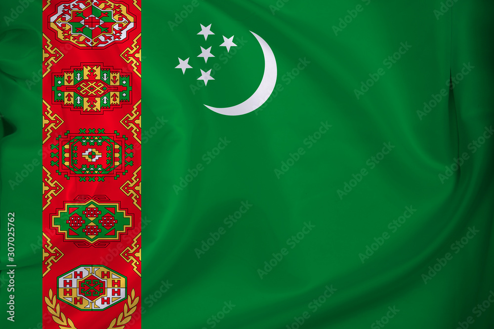 beautiful photo of a colored national flag of the modern state of Turkmenistan on a textured fabric, concept of tourism, emigration, economy and politics, close up
