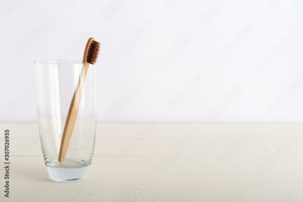 Natural bamboo toothbrushes in glass on white background. Biodegradable natural bamboo toothbrush. Eco friendly, Zero waste, Dental care, Plastic free concept. Copy space for text Natural bamboo toothbrushes in glass on white background. Biodegradable natural bamboo toothbrush. Eco friendly, Zero waste, Dental care, Plastic free concept. Copy space for text