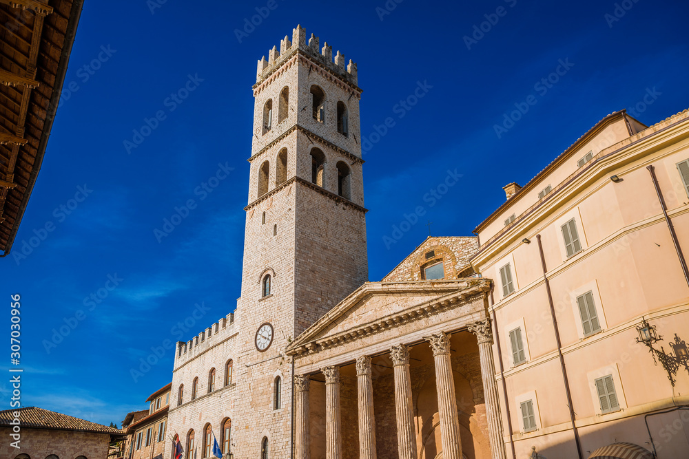 Medieval People's Tower and ancient roman Temple of Minerva in Assisi Communal Square, in the city historic center