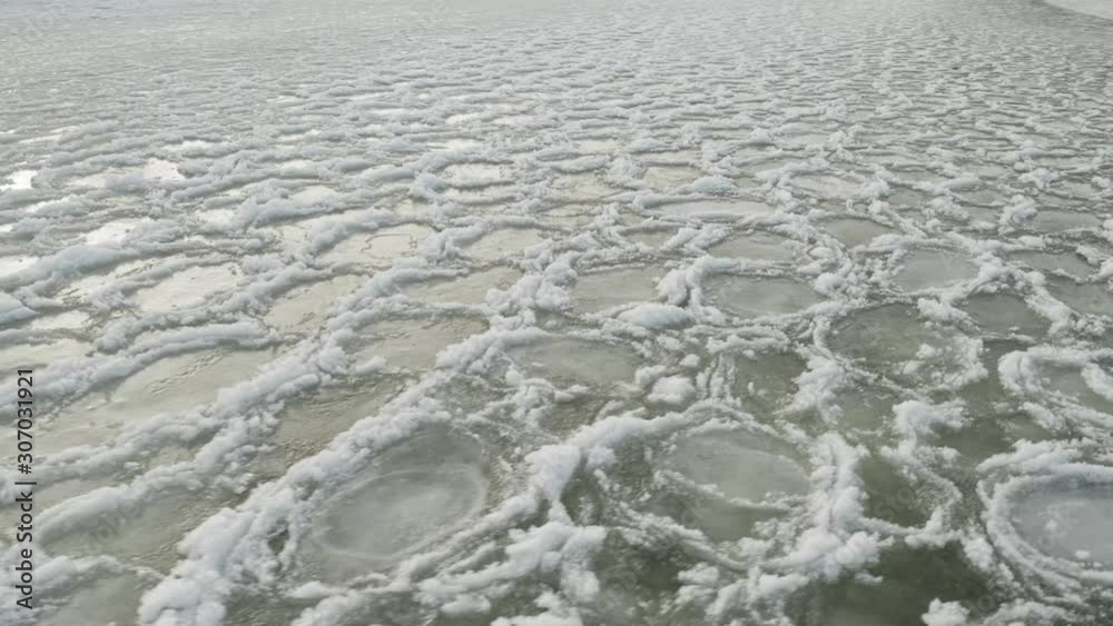 Rotating aerial frozen lake surface ice sheets 4K Rotating aerial frozen lake surface ice sheets 4K