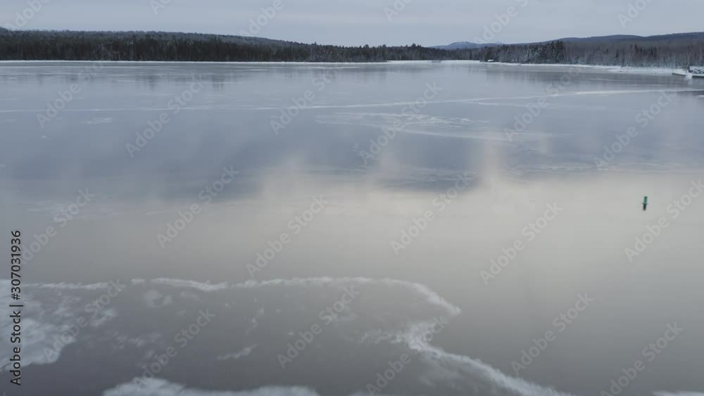 Reflective ice across frozen lake surface Aerial