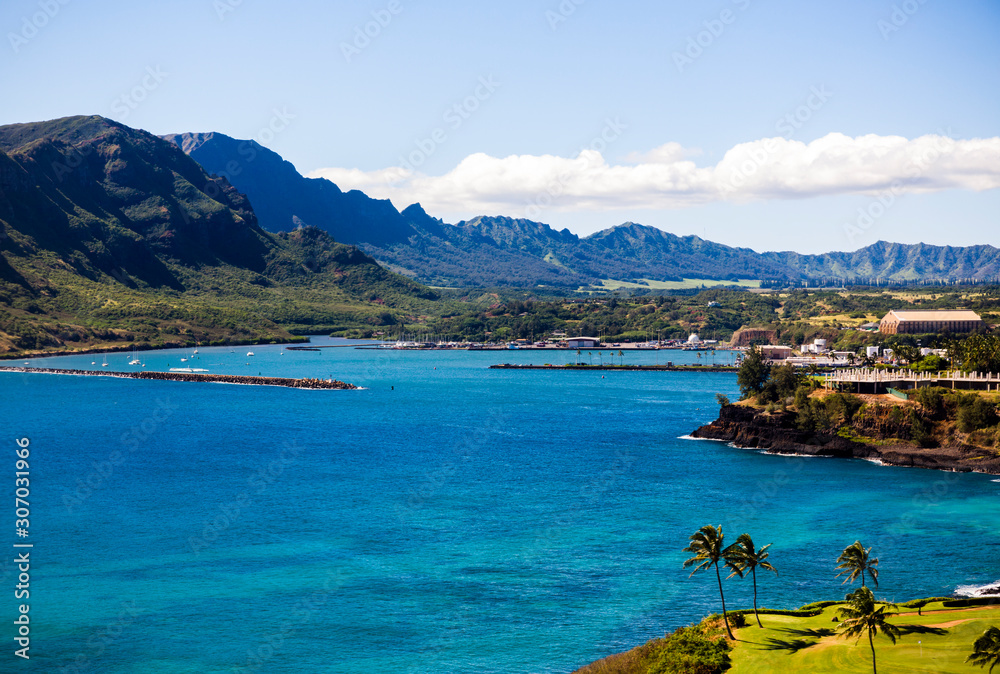 Aerial view of a golf course, mountains and bay on the coast of Kauai, Hawaii.  
