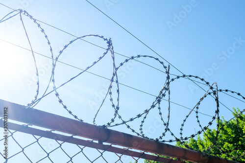 barbed wire on background of blue sky