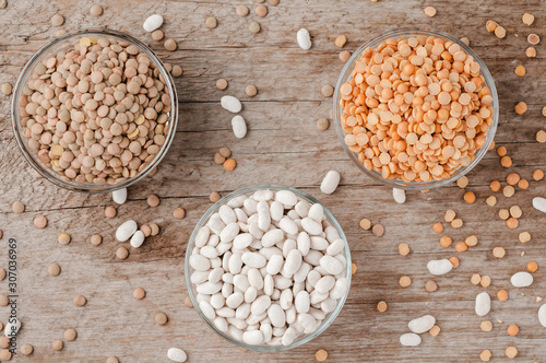 Three types of lentils on a wooden background photo