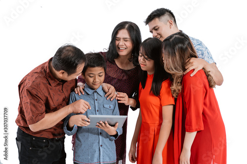 asian family using tablet pc together isolated over white background © Odua Images