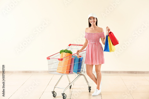 Happy young woman with shop...