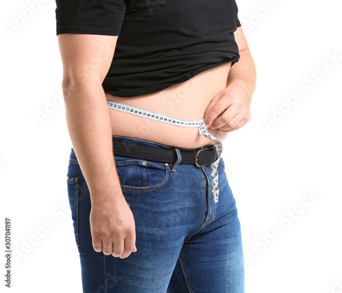 Overweight man measuring hi...