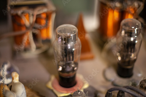 Fototapeta Naklejka Na Ścianę i Meble -  Old lamp inside the amplifier. Vintage sound technique.