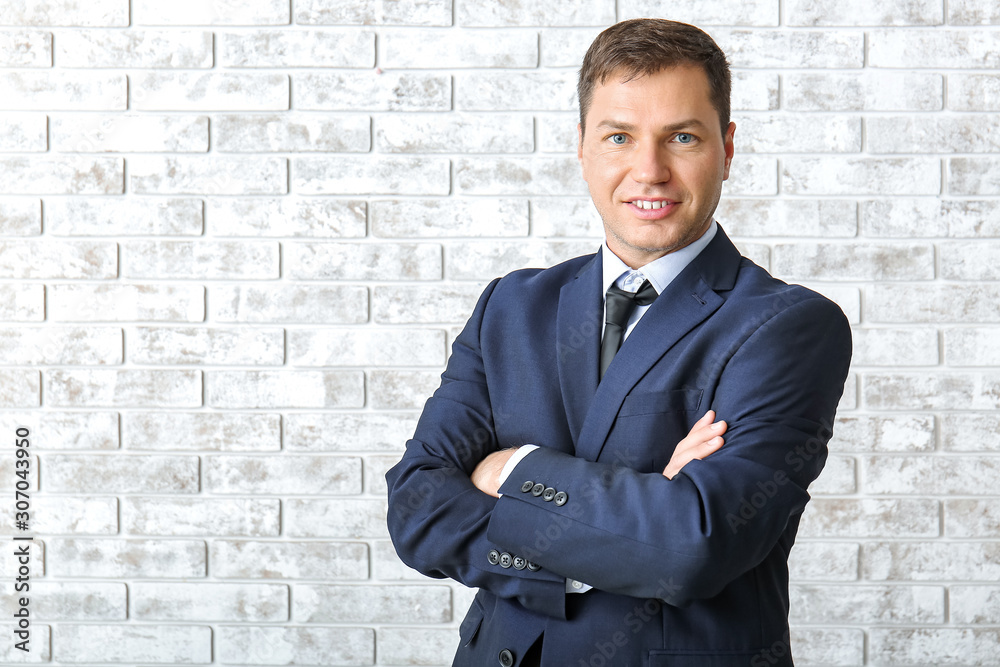 Portrait of handsome businessman on brick background Portrait of handsome businessman on brick background