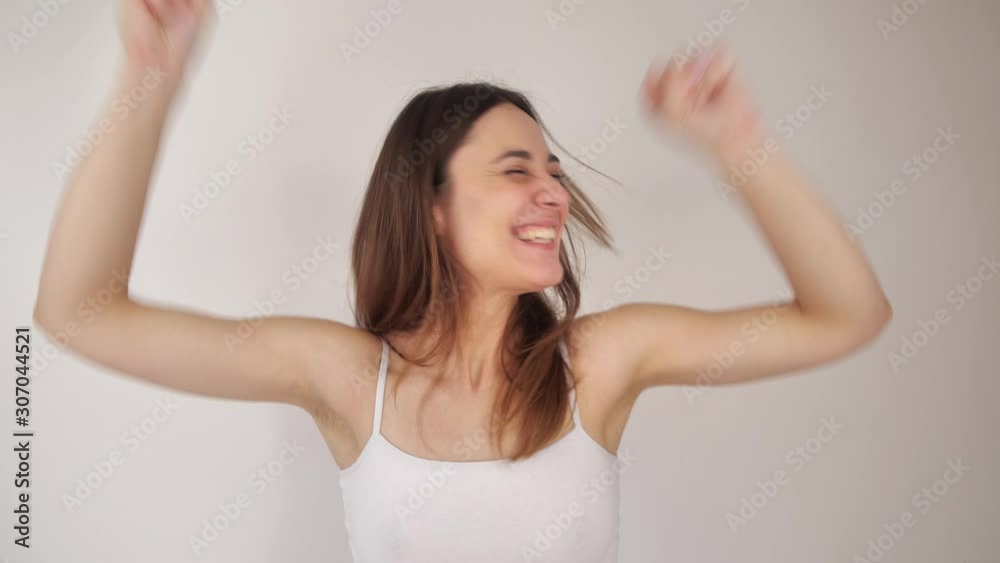 Beautiful young woman smiling hearing good news while standing isolated on white. 4k Beautiful young woman smiling hearing good news while standing isolated on white. 4k
