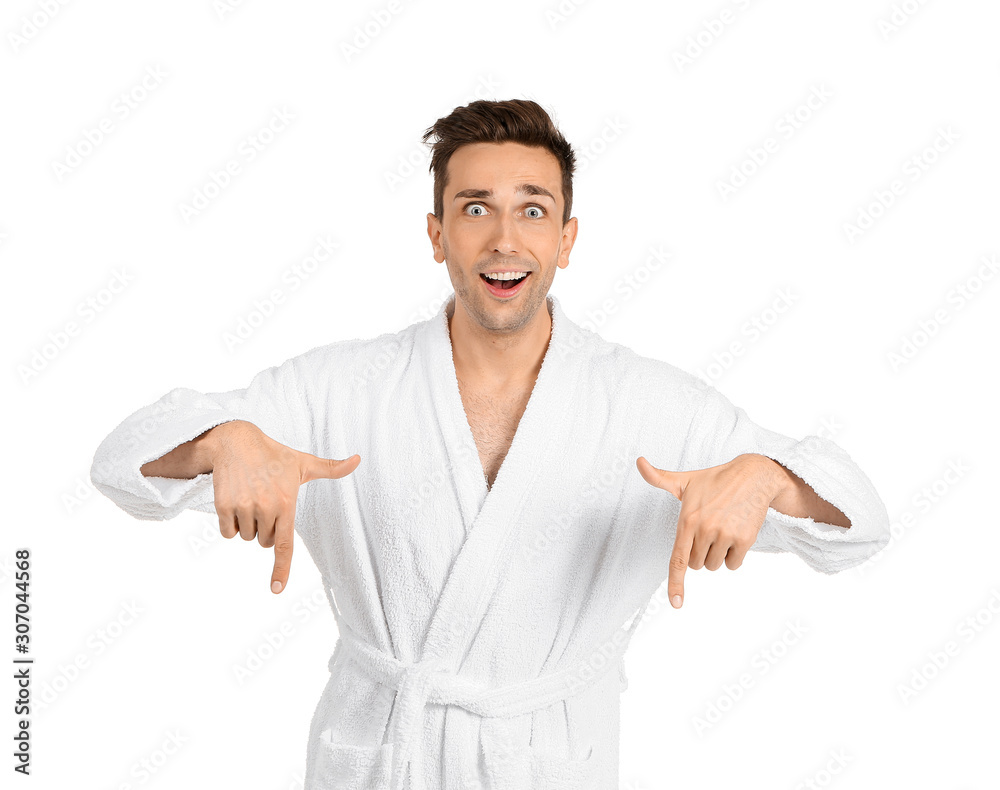 Excited man in bathrobe pointing at something on white background Excited man in bathrobe pointing at something on white background