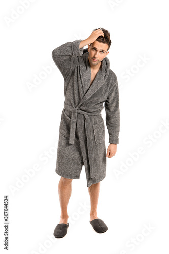 Handsome man in bathrobe on...