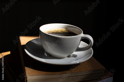 A coffee cup on a dark wooden background