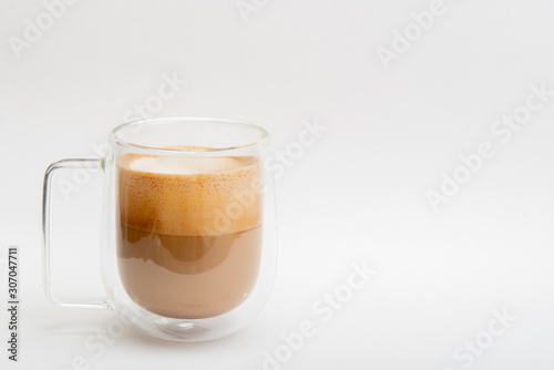 Hot Latte in double layer clear glass on white background