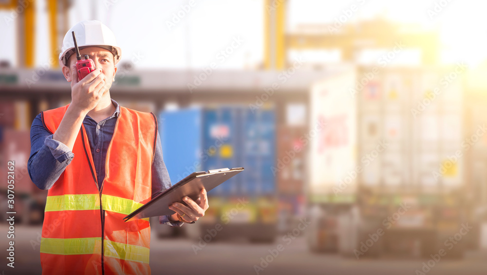 Fototapeta premium Operator control at the port, loading containers for trucks for export and importing logistic background, control staff in Asia, loading containers for trucks for export and import.
