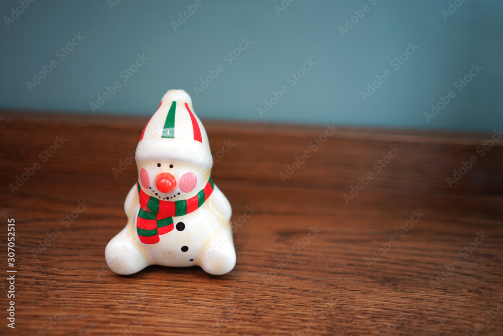 Christmas decorative small ceramic doll on timber table