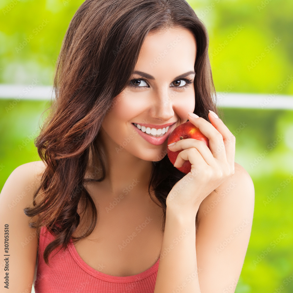 Young happy smiling lovely brunette woman with red apple Young happy smiling lovely brunette woman with red apple