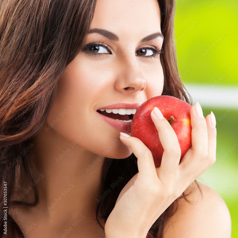 Young happy smiling lovely brunette woman with red apple Young happy smiling lovely brunette woman with red apple