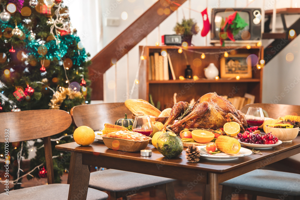 Roasted  chicken or turkey with sauce and grilled autumn vegetables: corn,pumpkin  on wooden table, top view, frame. Christmas or Thanksgiving Day food concept.