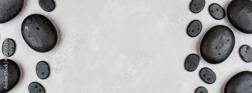Photography Top view of hot spa stones set for massage treatment on gray concrete background with copy space