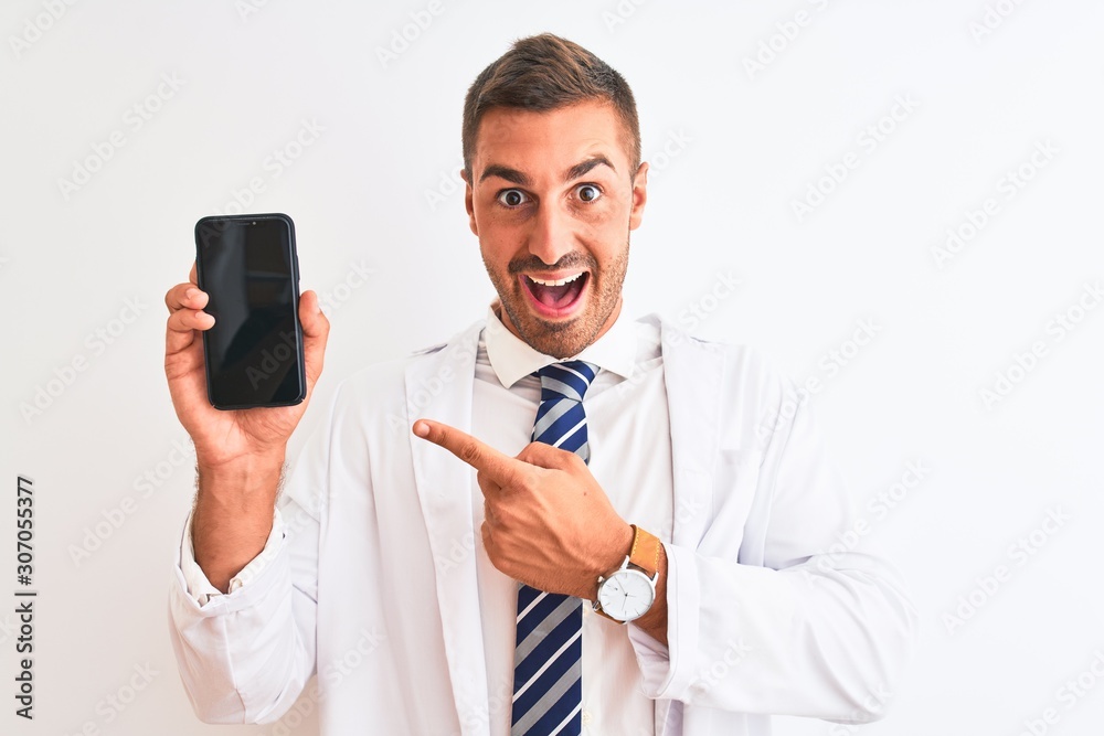 Naklejka premium Young scientist man showing smartphone screen over isolated background very happy pointing with hand and finger