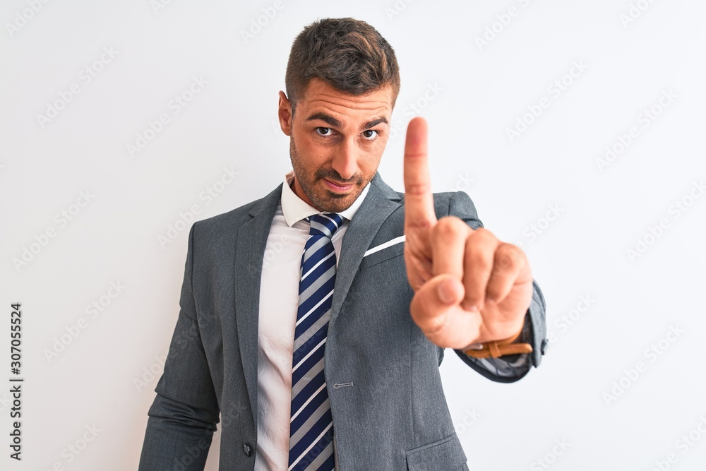 Young handsome business man wearing suit and tie over isolated background Pointing with finger up and angry expression, showing no gesture Young handsome business man wearing suit and tie over isolated background Pointing with finger up and angry expression, showing no gesture