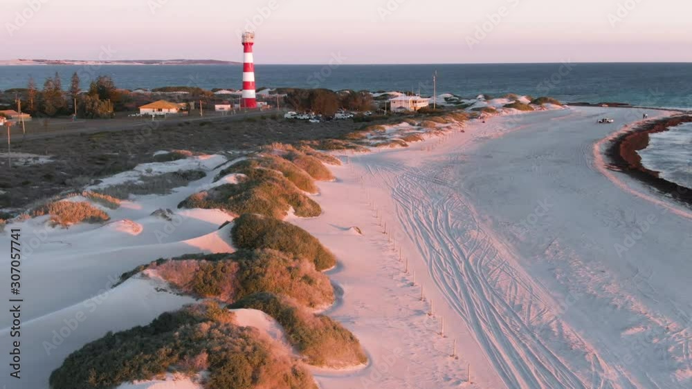 Aerial: Gorgeous sunset footage of Geraldton beach on west end and lighthouse in the background. Western Australia.