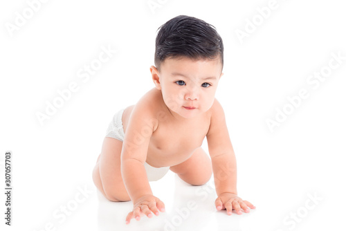 Little asian male toddler wearing diaper crawling on the floor over white background