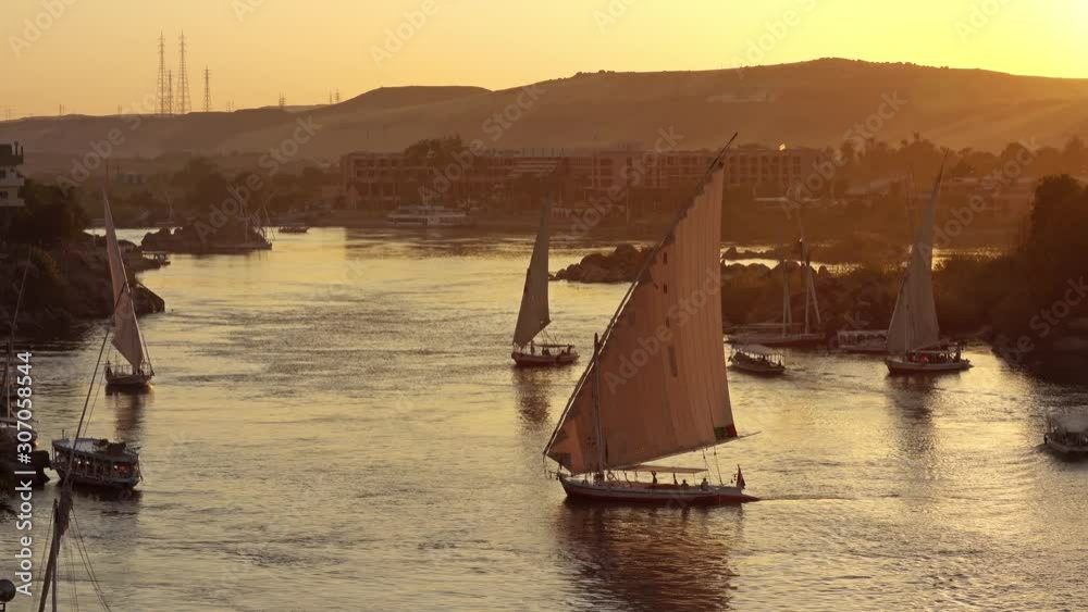 Beautiful view on felucca boats on Nile river in Aswan at sunset, Egypt, 4k