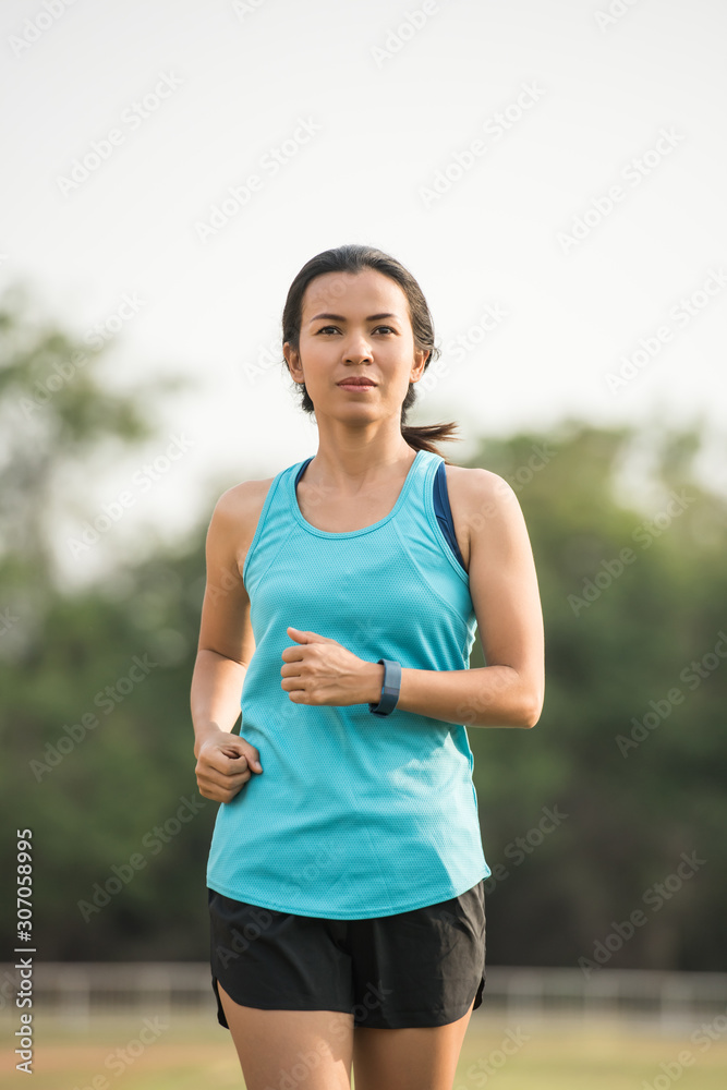 Pretty sporty woman jogging at park Pretty sporty woman jogging at park