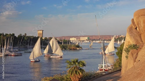 Beautiful landscape with felucca boats on Nile river in Aswan at sunset, Egypt, 4k photo