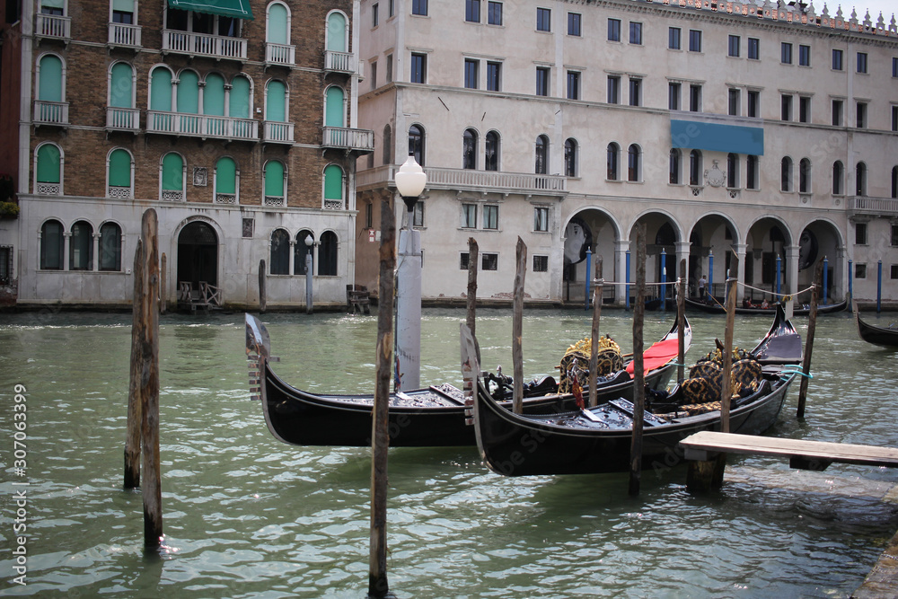 Fototapeta premium Gondolas travelling on Grand Canal Venice surrounding by historical attractive building, Venice, Italy, Commercial advertisement for day trip boat in Europe