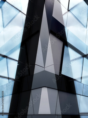 Modern office architecture. Trasparent fragments of industrial building exterior featuring windows and steel wall panels.  Abstract composition of complex geomteric structure.
