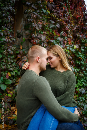 Beautiful couple walking down the street in sweaters and jeans © Дмитрий Ткачук